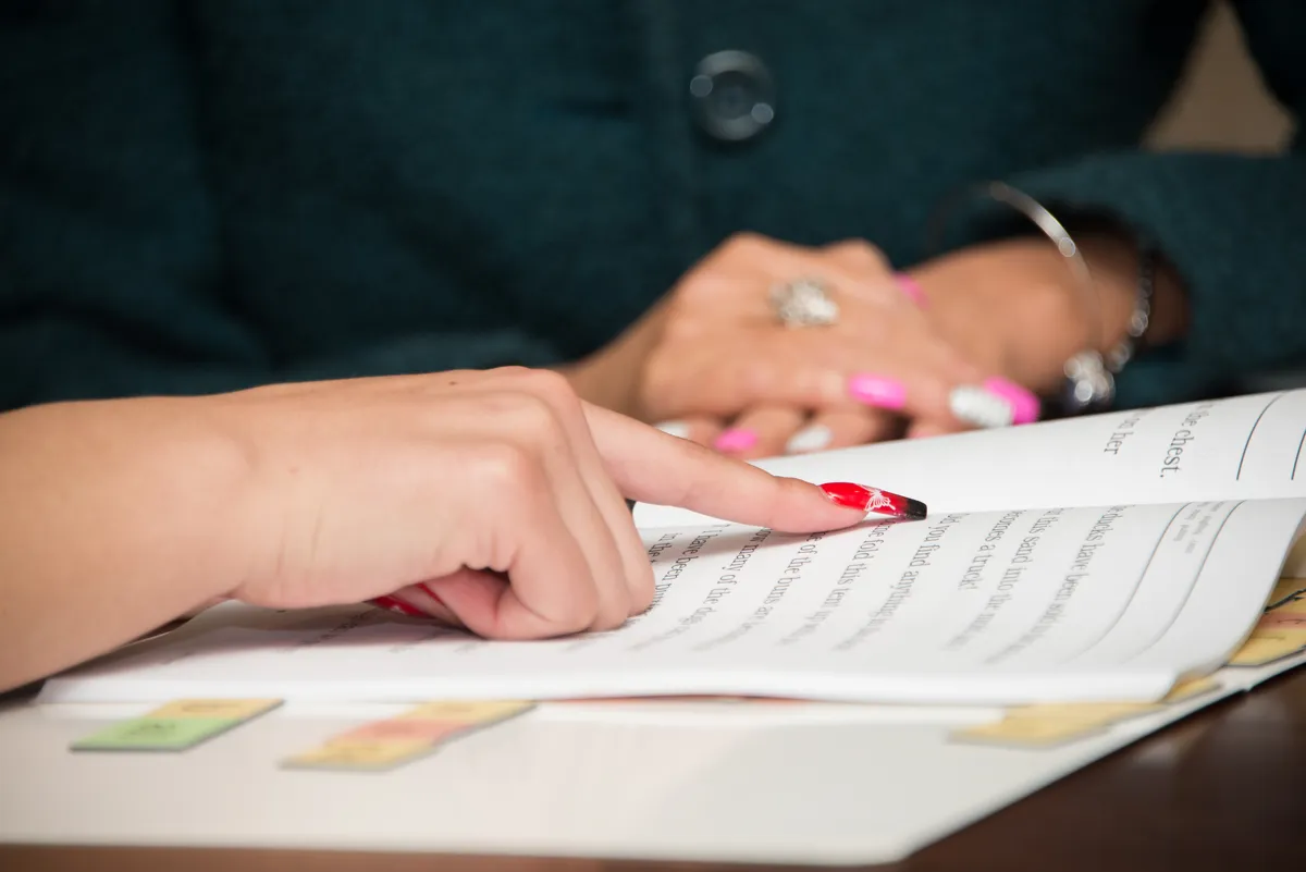 Close-up of guided reading comprehension during a therapy session