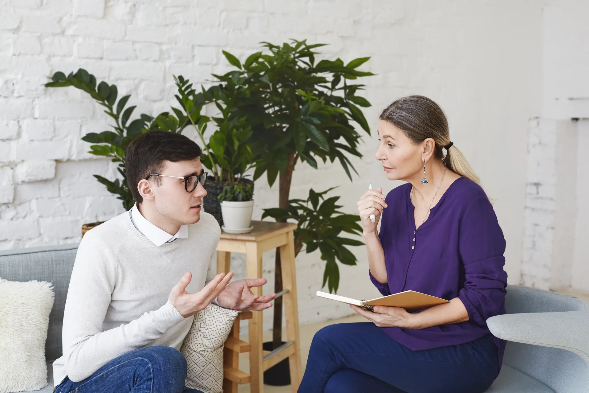 Adult client reviewing therapy progress with a speech-language pathologist