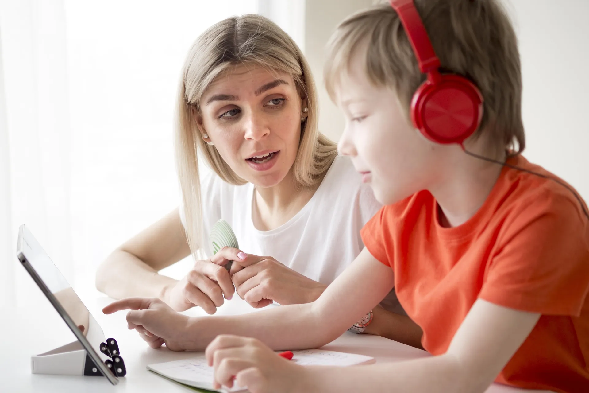 Speech therapist conducting precise AAC device assessment and matching process